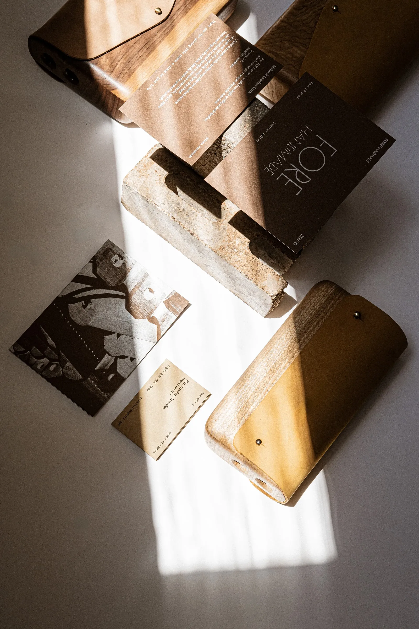 FORE bags laid out with a FORE HANDMADE card and illustrated cards around a stone