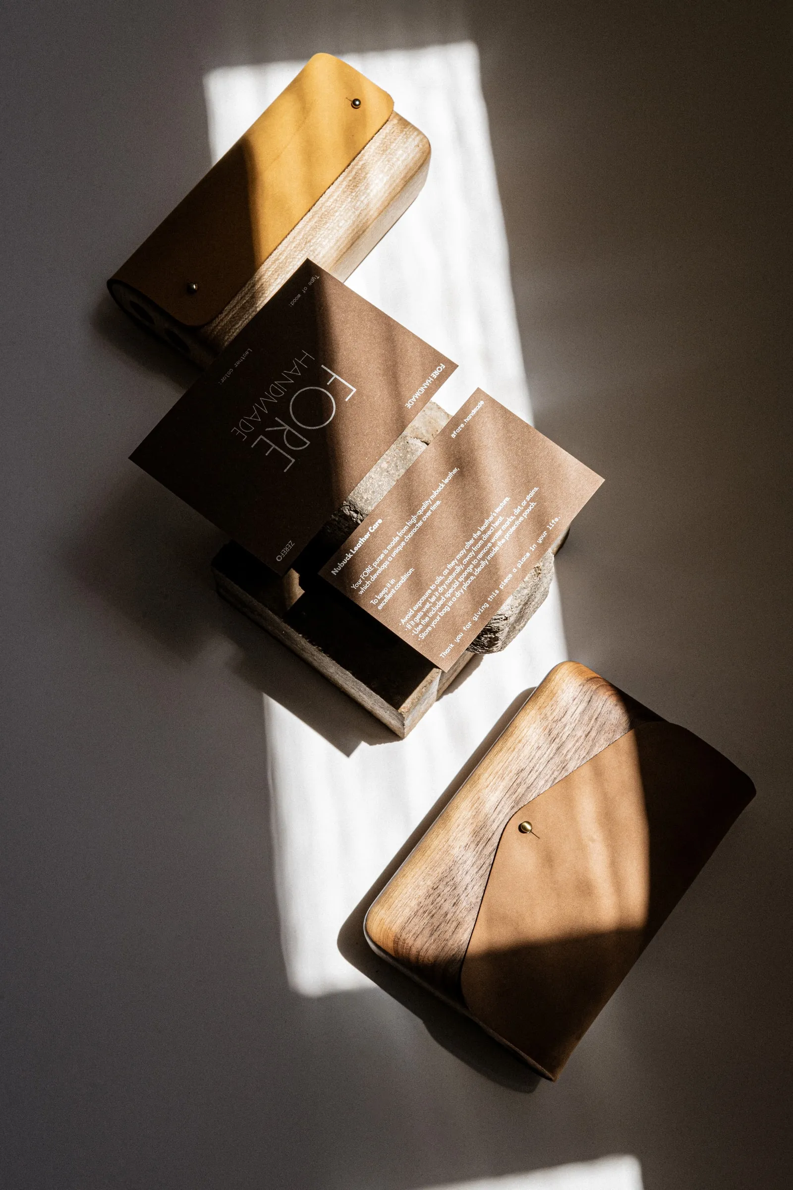 A FORE card and leaflets on top of the wooden bags in a band of sunlight