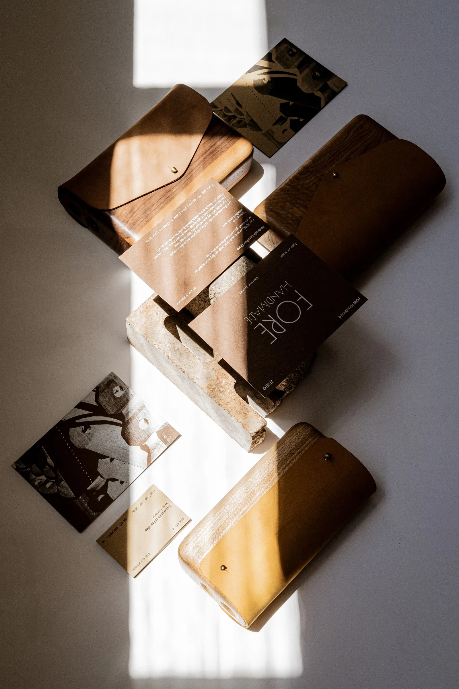 Overhead flat lay of FORE bags and cards in a strip of sunlight