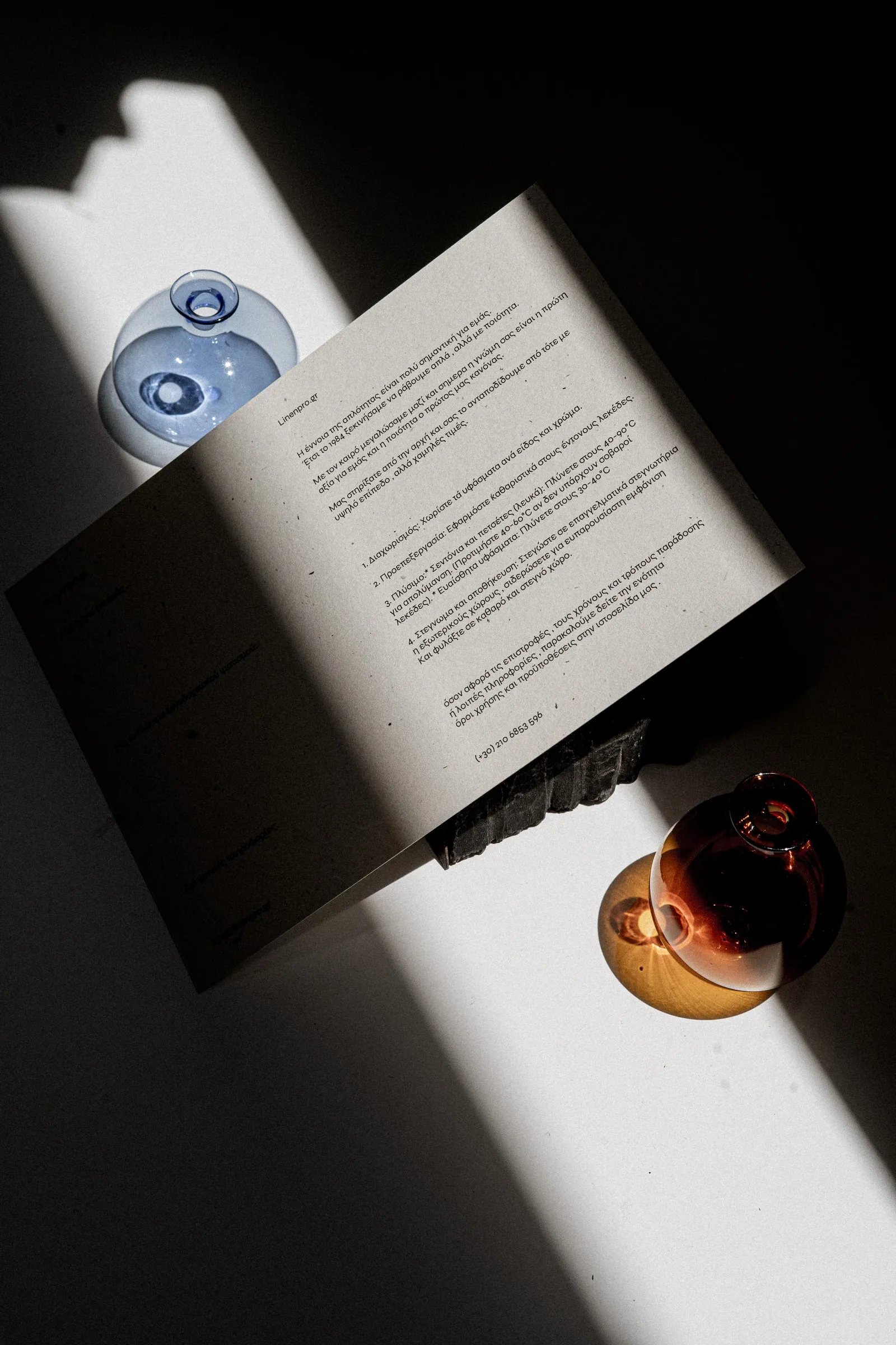 An open Linen Pro booklet at a text page, with blue and amber glass globes