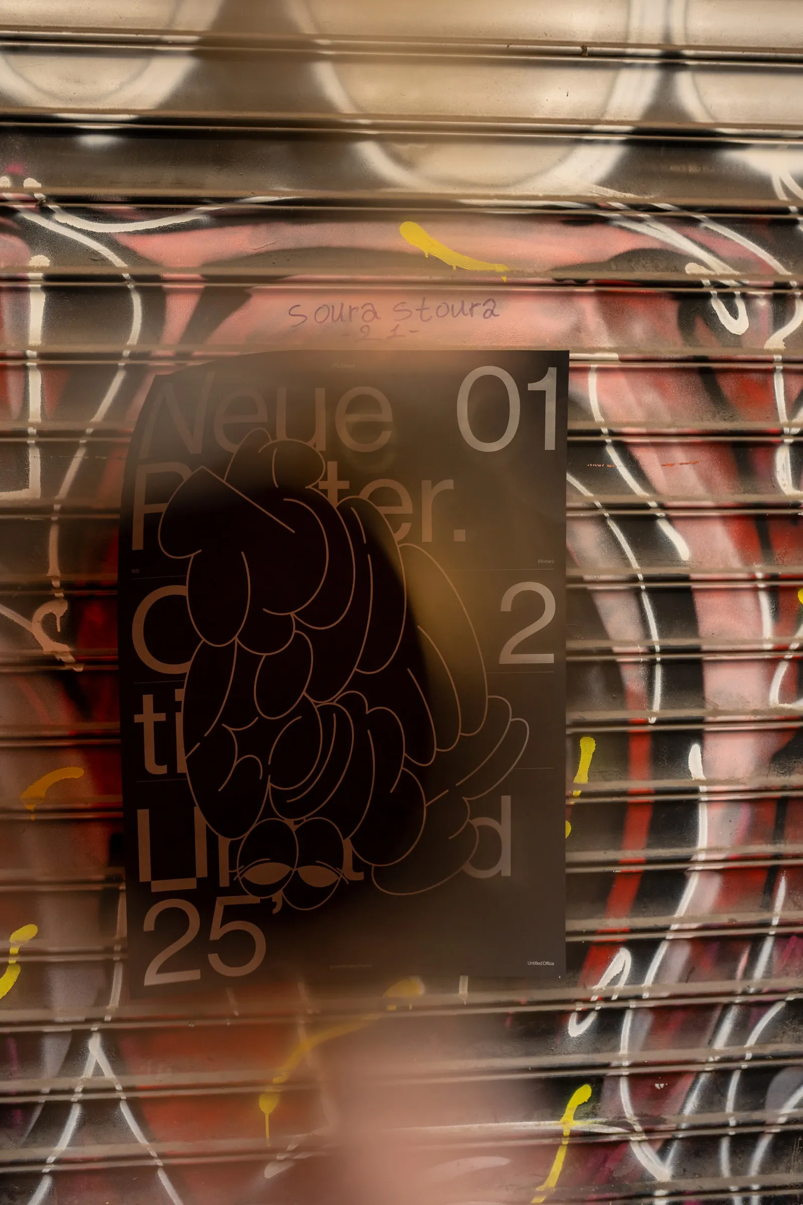The poster on a red graffiti shutter, blurred by motion