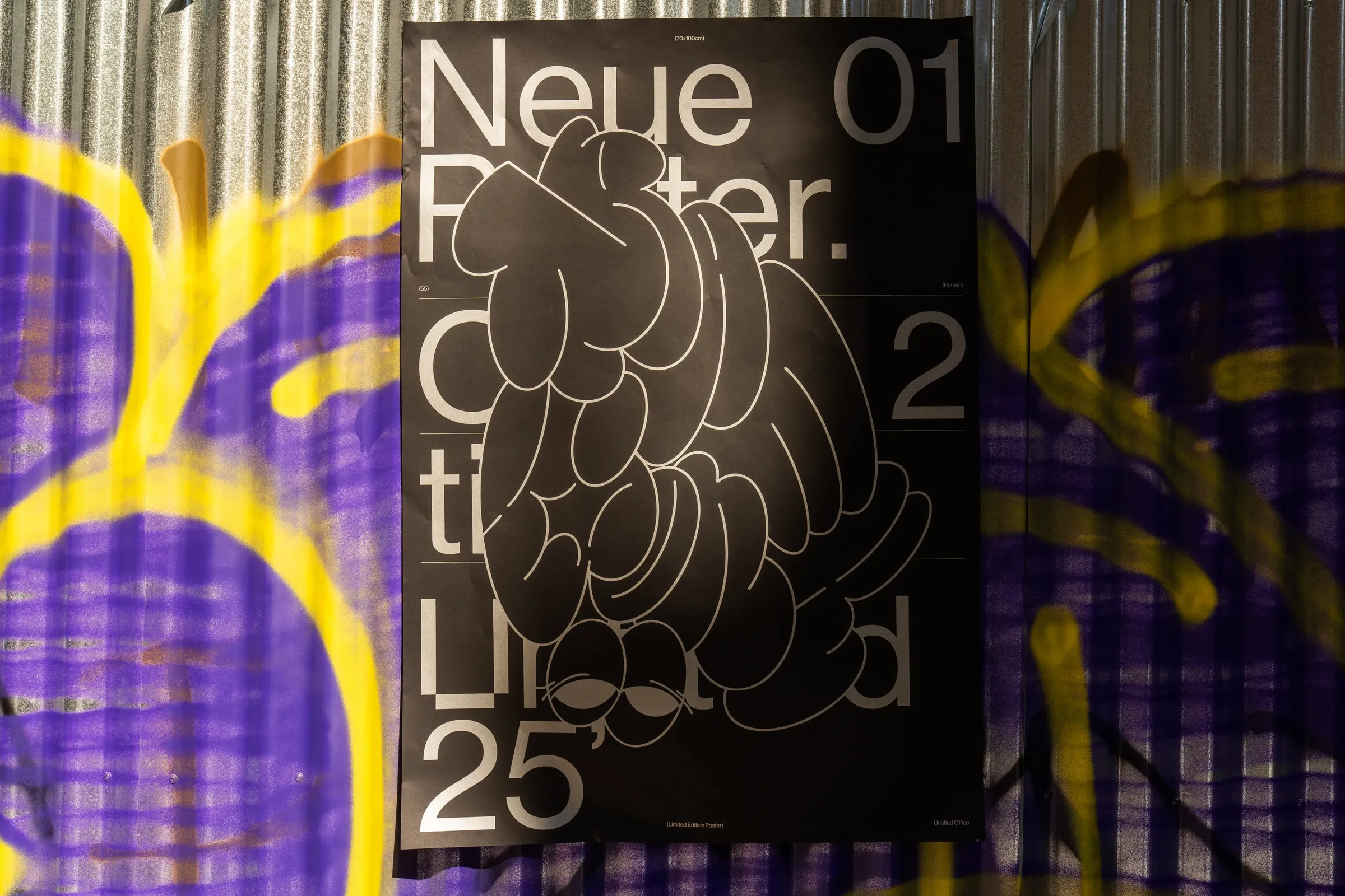 The poster on a purple and yellow graffiti wall